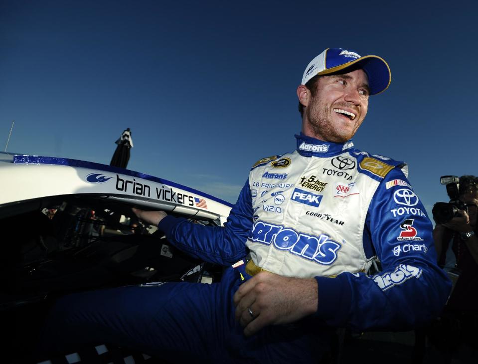Brian Vickers climbs out of his car after winning the pole for Sunday&amp;#39;s NASCAR Sprint Cup Series auto race at Talladega Superspeedway Saturday, Oct. 18, 2014, in Talladega, Ala. (AP Photo/Rainier Ehrhardt)