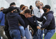 Police officers detain a protester during a rally against the removal of opposition candidates from the presidential elections in Minsk, Belarus, Tuesday July 14, 2020. Election authorities in Belarus on Tuesday barred two main rivals of authoritarian leader Alexander Lukashenko from running in this summer's presidential election. (AP Photo/Sergei Grits)