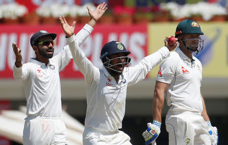 Cricket - India v Australia - Third Test cricket match - Jharkhand State Cricket Association Stadium, Ranchi, India - 16/03/17 - India's Ajinkya Rahane (L) and Cheteshwar Pujara (C) successfully appeals for the dismissal of Australia's Shaun Marsh. REUTERS/Adnan Abidi