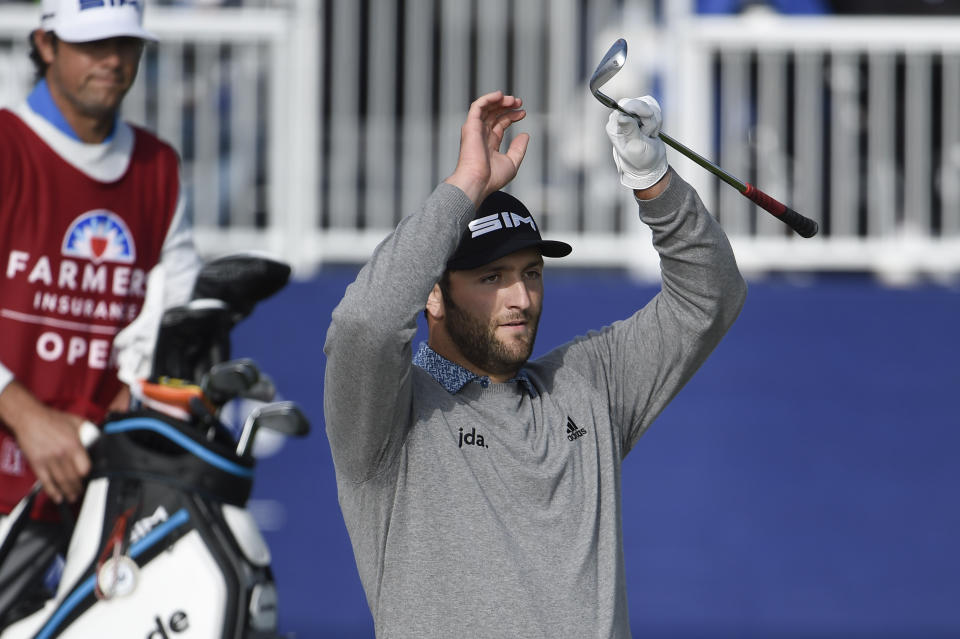 Jon Rahm of Spain reacts after hitting a bunker shot on the 15th hole of the South Course at Torrey Pines Golf Course during the third round of the Farmers Insurance golf tournament Saturday, Jan. 25, 2020, in San Diego. (AP Photo/Denis Poroy)