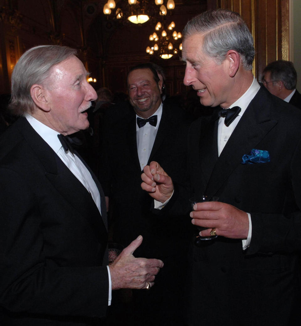 Britain's Prince Charles chats with actor Leslie Philips at the Royal Shakespeare Company's gala fund raising dinner for their 'Complete Works Festival', in London, on May 17, 2006. Leslie Phillips, the British actor best known for his roles in the bawdy “Carry On” comedies and as the voice of the Sorting Hat in the “Harry Potter” movies, has died. He was 98. His agent Jonathan Lloyd confirmed Tuesday that Phillips died “peacefully at home” on Monday. (Stefan Rousseau/Pool Photo via AP)