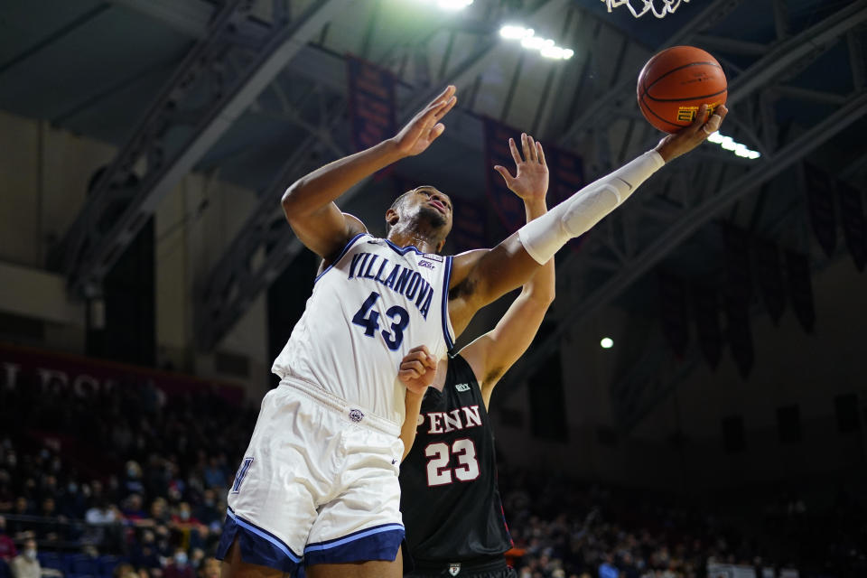 Villanova's Eric Dixon, left, got sup for a shot against Pennsylvania's Michael Wang during the first half of an NCAA college basketball game, Wednesday, Dec. 1, 2021, in Philadelphia. (AP Photo/Matt Slocum)