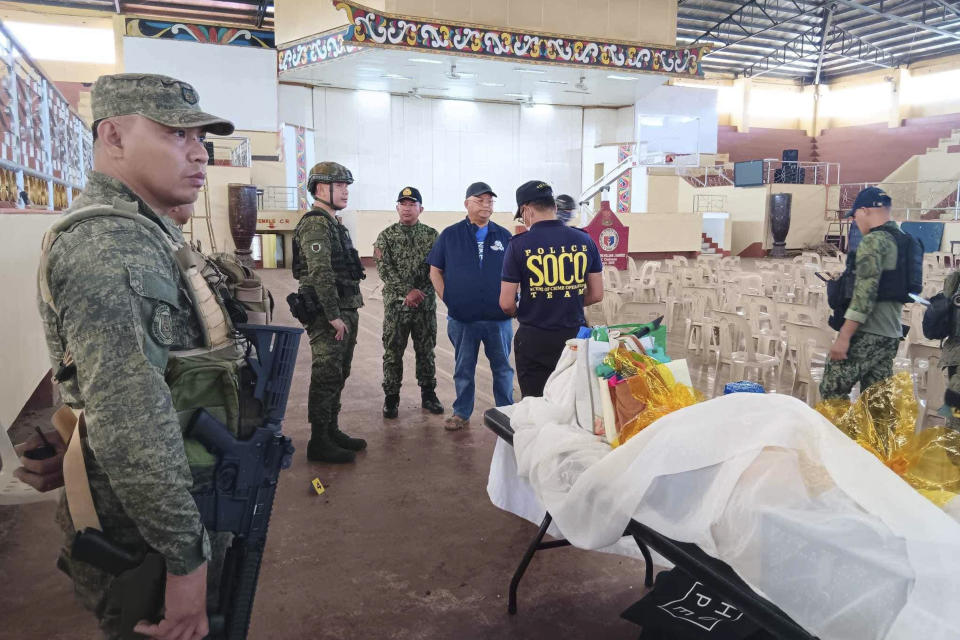 In this handout photo provided by the Provincial Government of Lanao Del Sur - Public Information Office, law enforcers conduct an investigation at the site of an explosion in Marawi city, southern Philippines on Sunday Dec. 3, 2023. A powerful explosion believed caused by a bomb ripped through a Catholic Mass and killed several people and wounded dozens of others Sunday in a predominantly Muslim city in the southern Philippines, officials said. (Provincial Government of Lanao Del Sur - Public Information Office via AP)