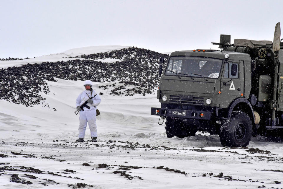 A Russian serviceman stands guard by a military truck on the island of Alexandra Land, part of the Franz Josef Land archipelago, on May 17. (Maxime Popov / AFP - Getty Images)