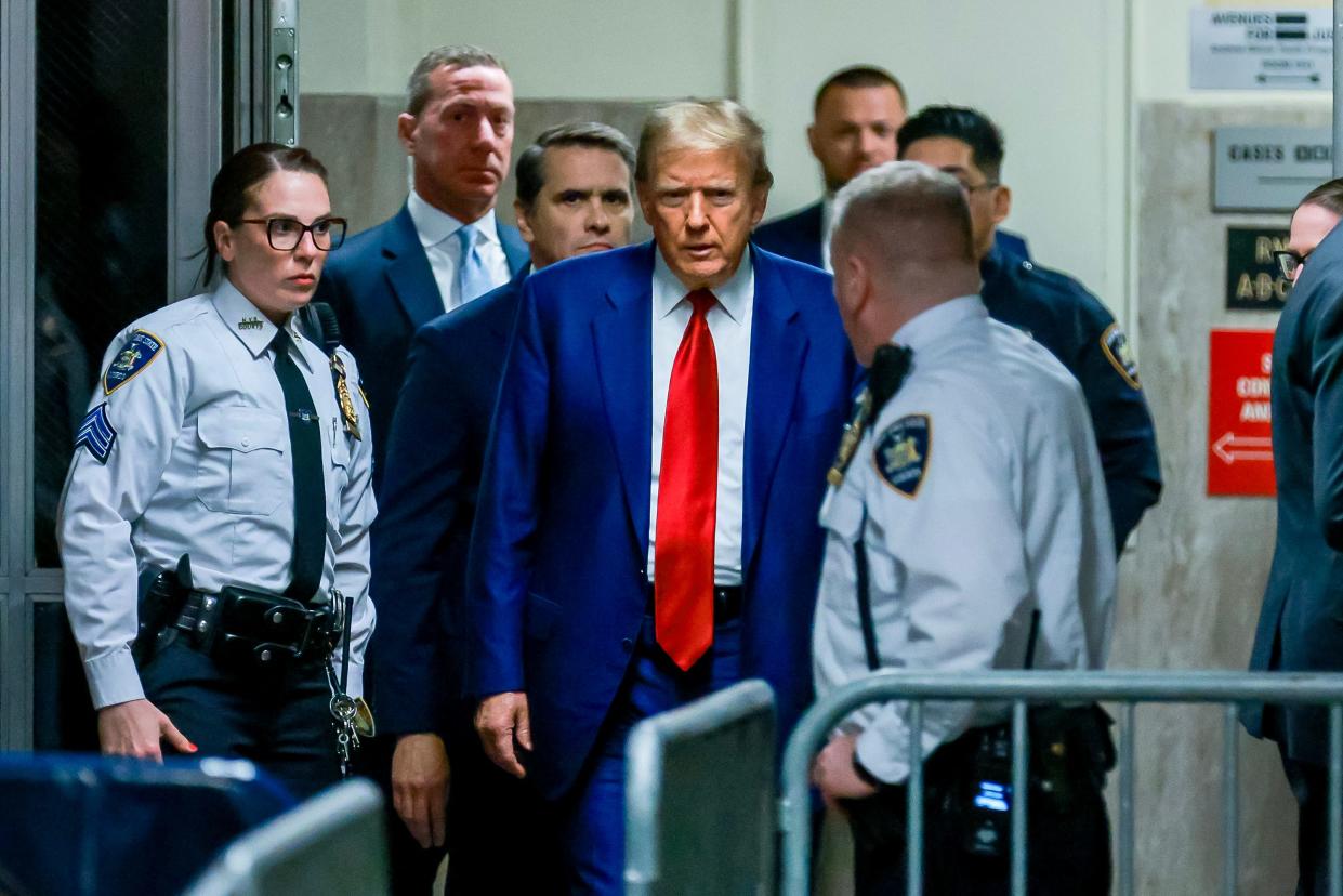 Former US President Donald Trump arrives for his hearing to determine the date of his trial for allegedly covering up hush money payments linked to extramarital affairs, at Manhattan Criminal Court in New York City on March 25, 2024. Trump faces twin legal crises today in New York, where he could see the possible seizure of his storied properties over a massive fine as he separately fights to delay a criminal trial even further.