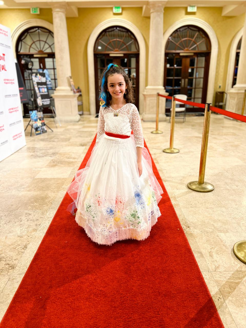 Wearing a homemade dress, actor Ella Grace Helton, 11, of Melbourne walks the red carpet at the Melbourne International Film Festival in 2023. Her second film, "The Muralist," premiered at the event.