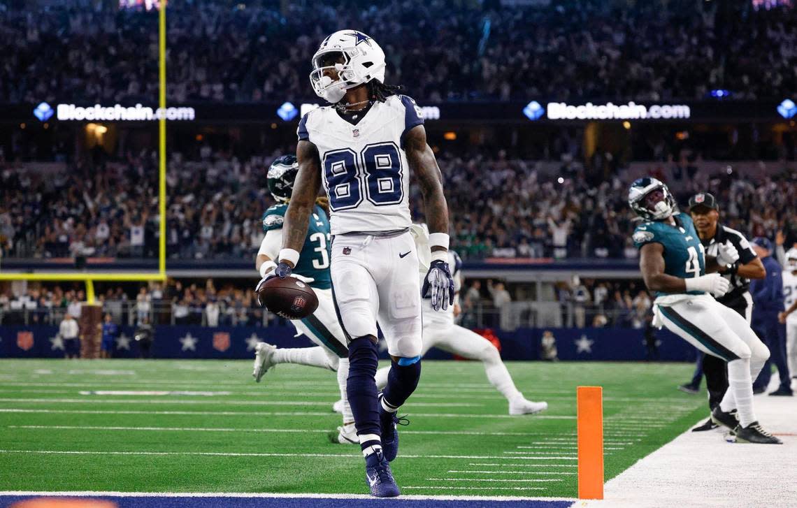 Dallas Cowboys wide receiver CeeDee Lamb scores a touchdown against the Philadelphia Eagles during the first quarter on Sunday, December 10, 2023, at AT&T Stadium in Arlington.