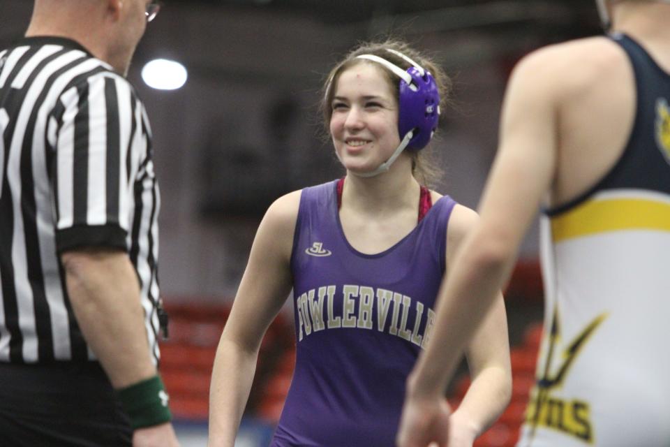 Fowlerville's Maggie Buurma smiles at the official before her match in the state Division 2 wrestling quarterfinals Friday, Feb. 24, 2023 at Wings Event Center.