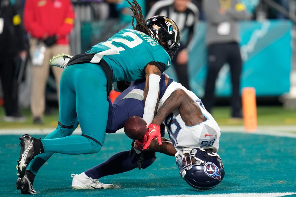 Jacksonville Jaguars safety Rayshawn Jenkins (2) breaks up a pass in the end zone intended for Tennessee Titans tight end Chigoziem Okonkwo in the second half of an NFL football game, Saturday, Jan. 7, 2023, in Jacksonville, Fla. (AP Photo/John Raoux)