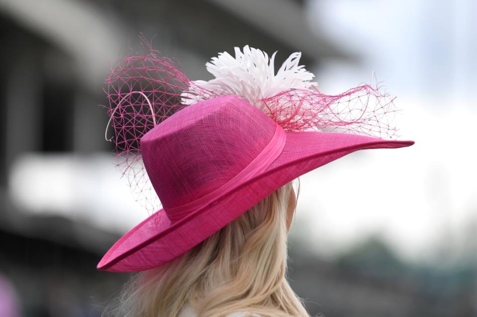 Blonde woman in decorated pink fedora
