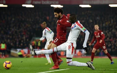 Crystal Palace's Senegalese midfielder Cheikhou Kouyate (2nd R) vies with Liverpool's Egyptian midfielder Mohamed Salah (C) during the English Premier League football match between Liverpool and Crystal Palace at Anfield in Liverpool, north west England on January 19, 2019. (Photo by Paul ELLIS / AFP) / RESTRICTED TO EDITORIAL USE. No use with unauthorized audio, video, data, fixture lists, club/league logos or 'live' services. Online in-match use limited to 120 images. An additional 40 images may be used in extra time. No video emulation. Social media in-match use limited to 120 images. An additional 40 images may be used in extra time. No use in betting publications, games or single club/league/player publications - Credit: AFP