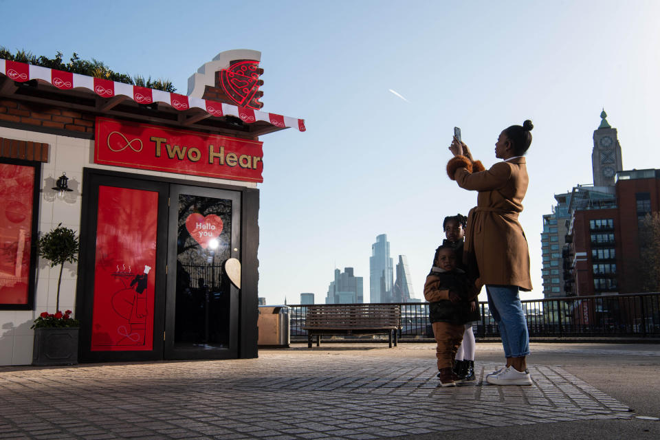 <p>EDITORIAL USE ONLY Sarah Nicholas-Kyei and her children Eden, aged four and Roman, aged two arrive at the Two Hearts Pizzeria dining experience in London, which Virgin Media is showcasing to bring people closer together and offer guests the chance to share a pizza with a loved one 400 miles apart via hologram, as if sat at the same table. Picture date: Thursday April 15, 2021.</p>
