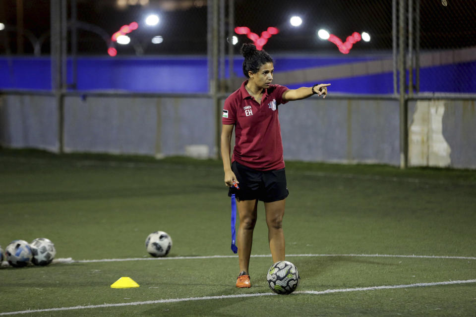 Insherah Heyasat, a football player, gives instructions during a training of the Orthodox Club's women's team in Amman, Jordan, Saturday, Oct. 22, 2022. Women's soccer has been long been neglected in the Middle East, a region that is mad for the men's game and hosts the World Cup for the first time this month in Qatar. (AP Photo/Raad AL-Adayleh)