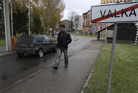 A man walks past a border crossing point with Estonia in Valka October 25, 2013. REUTERS/Ints Kalnins