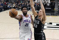 Philadelphia 76ers center Joel Embiid (21) drives to the basket against San Antonio Spurs forward Zach Collins (23) during the first half of an NBA basketball game in San Antonio, Friday, Feb. 3, 2023. (AP Photo/Eric Gay)