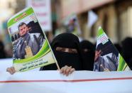 Yemeni women hold a portrait of Shiite Huthi rebel leader Abdulmalik al-Huthi at a rally in Sanaa, on March 31, 2015 to protest against the Saudi-led Arab air strikes on Huthi militia targets