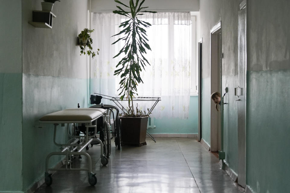 A girl peeks out from the door in Rivne Regional Children's Hospital, in Rivne, Ukraine, on March 14, 2019. As Ukrainians prepare to go the polls in a presidential election March 31, millions have already voted with their feet, by leaving the country mired by corruption, poverty and conflict. (AP Photo/Mstyslav Chernov)