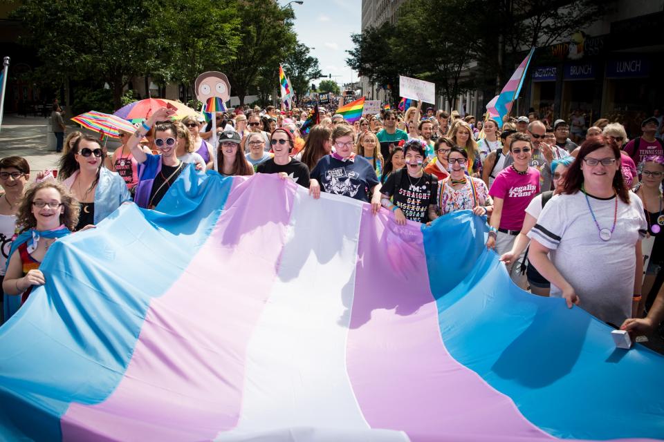 Marchers carry a flag during the Nashville Pride Equality Walk in downtown Nashville, Tenn., Saturday, June 24, 2017.