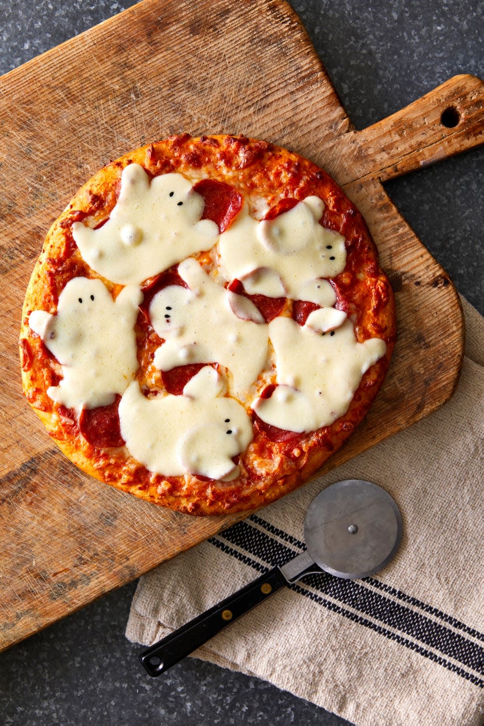 a pizza with mozzarella ghosts melted on top