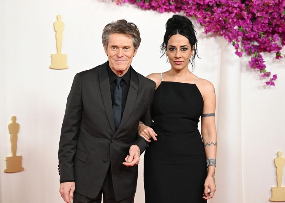 Willem Dafoe and Giada Colagrande arrive at the 96th Academy Awards.