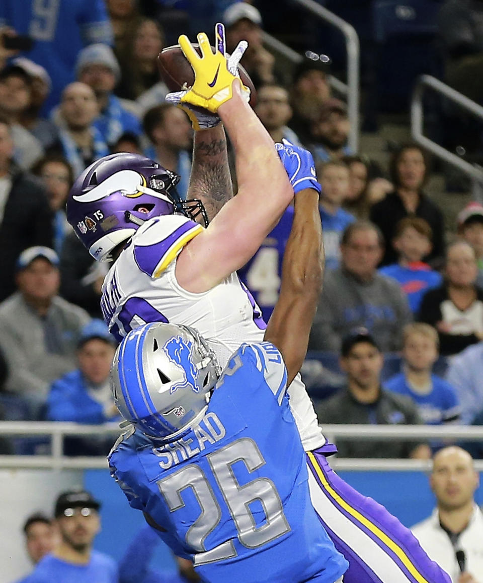 Minnesota Vikings tight end Kyle Rudolph, defended by Detroit Lions defensive back DeShawn Shead (26), catches a 44-yard pass for a touchdown with no time on the clock during the first half of an NFL football game, Sunday, Dec. 23, 2018, in Detroit. (AP Photo/Rey Del Rio)