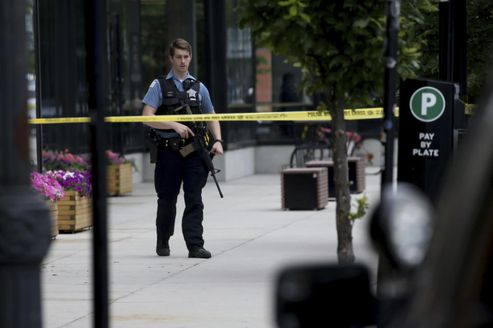 Chicago police investigate in the 1300 block of West Taylor Street after officials said an officer was shot multiple times while responding to a call of a domestic disturbance in a University Village neighborhood apartment building, Friday morning, July 1, 2022, in Chicago. (Antonio Perez/Chicago Tribune via AP)