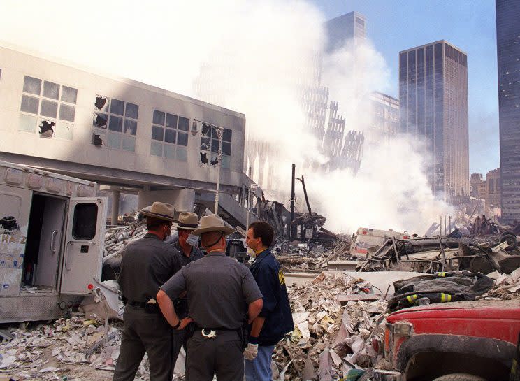 State police join rescue workers amid the rubble of the World Trade Center, Sept. 12, 2001. (Photo: Virgil Case/AP)