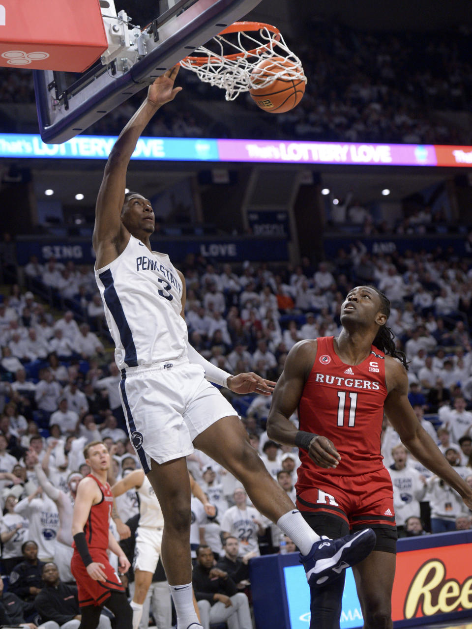 Rutgers' Clifford Omoruyi (11) watches as Penn State's Kebba Njie (3) scores during the first half of an NCAA college basketball game, Sunday, Feb. 26, 2023, in State College, Pa. (AP Photo/Gary M. Baranec)