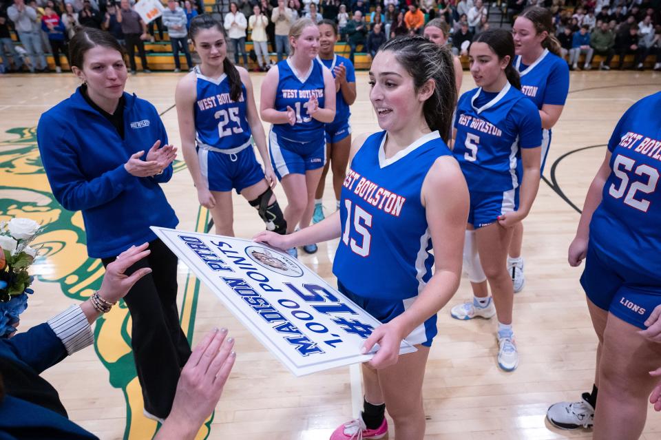 West Boylston's Maddie Pitro receives a sign after scoring her 1,000th point during the Clinton Holiday Tournament on Friday.