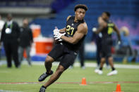 Wisconsin running back Jonathan Taylor runs a drill at the NFL football scouting combine in Indianapolis on Friday, Feb. 28, 2020. (AP Photo/Charlie Neibergall)