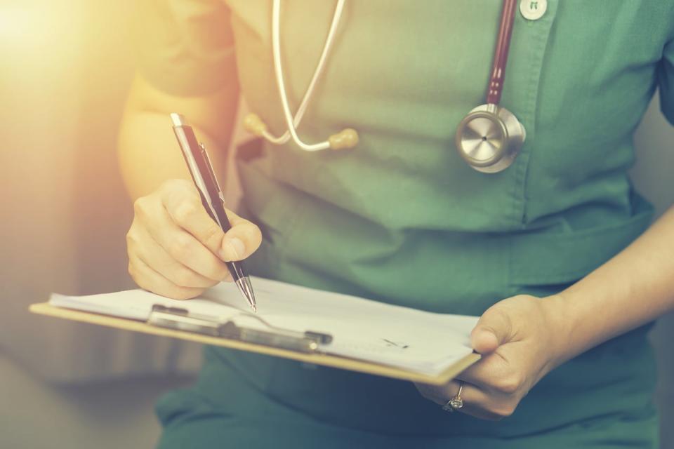 female doctor,surgeon,nurse,pharmacy with stethoscope on hospital holding clipboard,writing a prescription,Medical Exam,Healthcare and medical concept,test results,vintage color,selective focus. Photo ID: 440808748