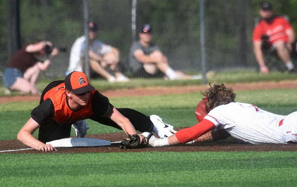 Amanda-Clearcreek senior Ryan Chambers tries to tag out a runner at third during Wednesday's Division III District Final at Olentangy Orange High School. The Aces lost to Fredericktown 5-1.