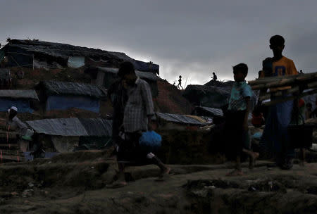 A Rohingya refugee child runs as night falls in a camp in Cox's Bazar, Bangladesh, September 28, 2017. REUTERS/Cathal McNaughton