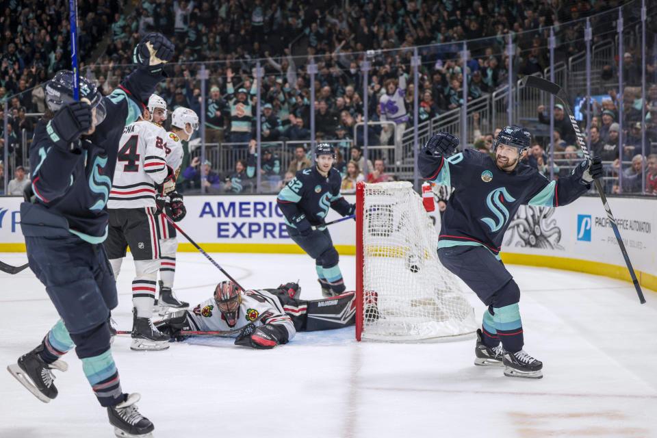 Seattle Kraken left wing Tomas Tatar, right, celebrates a goal by left wing Brandon Tanev, left, on Chicago Blackhawks goaltender Arvid Soderblom during the second period of an NHL hockey game Wednesday, Jan. 24, 2024, in Seattle. (AP Photo/Jason Redmond)