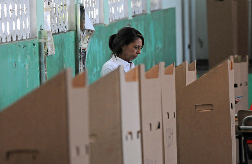 A woman mark her ballot during the presidential election in Santo Domingo, Dominican Republic, Sunday May 20, 2012. (AP Photo/Manuel Diaz)