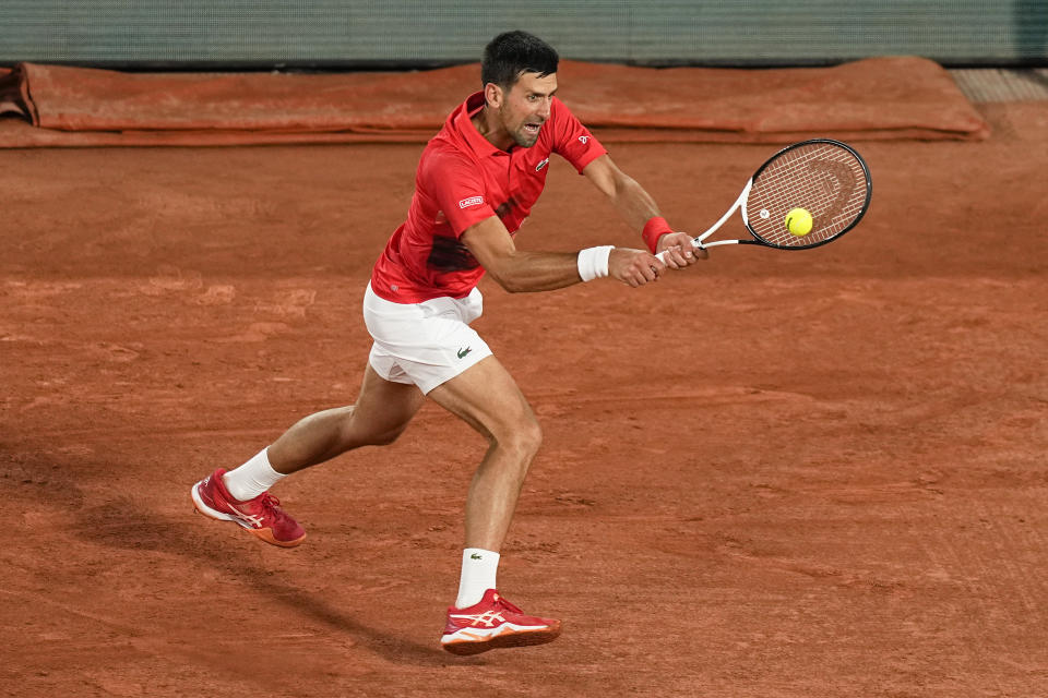 Serbia's Novak Djokovic plays a shot against Japan's Yoshihito Nishioka during their first round match at the French Open tennis tournament in Roland Garros stadium in Paris, France, Monday, May 23, 2022. (AP Photo/Michel Euler)