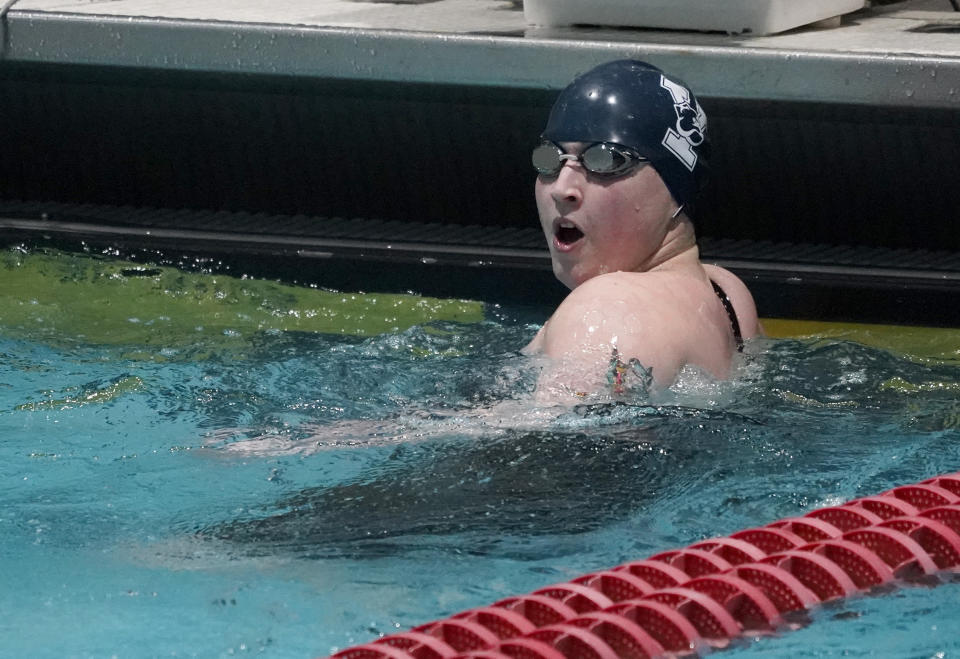 Yale's Iszac Henig reacts after setting a pool record in a 50-yard freestyle qualifying event at the Ivy League Women's Swimming and Diving Championships at Harvard University, Thursday, Feb. 17, 2022, in Cambridge, Mass. Henig, who is transitioning to male but hasn't begun hormone treatments yet, is swimming for Yale's women's team. (AP Photo/Mary Schwalm)