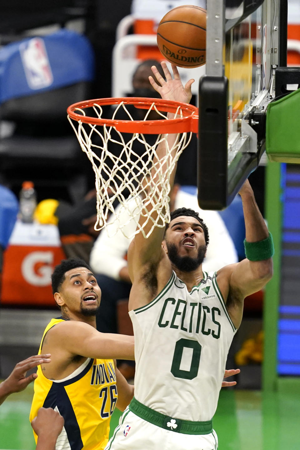 Boston Celtics forward Jayson Tatum (0) drives to the hoop past Indiana Pacers guard Jeremy Lamb (26) in the second half of an NBA basketball game, Friday, Feb. 26, 2021, in Boston. (AP Photo/Elise Amendola)
