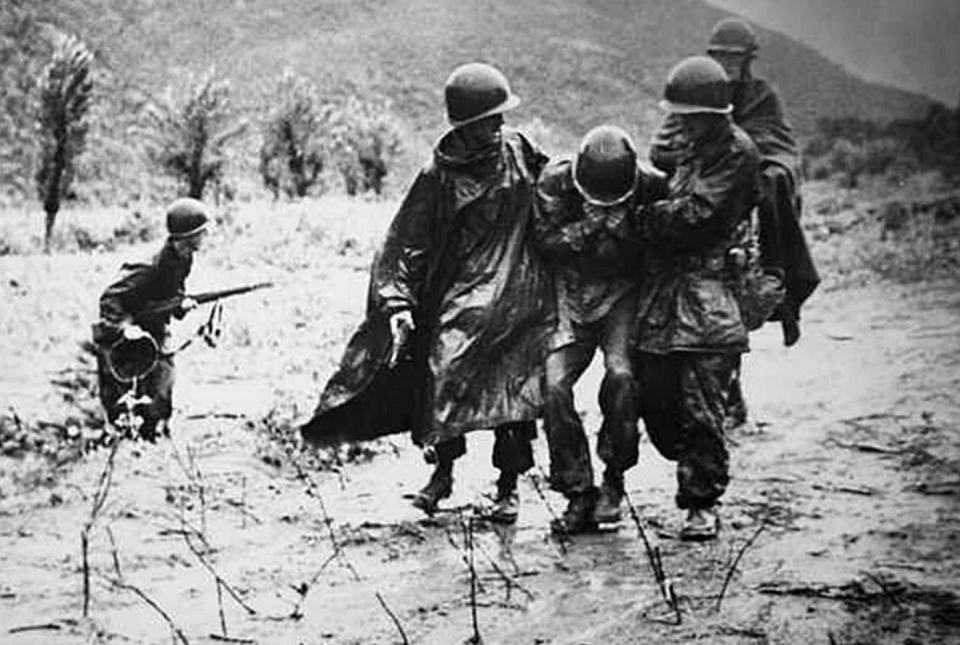 <span class="caption">Army chaplain Emil Kapaun helps a soldier on the battlefield during the Korean War in 1952.</span> <span class="attribution"><a class="link " href="https://www.gettyimages.com/detail/news-photo/photograph-of-captain-emil-kapaun-helping-another-soldier-news-photo/566448641?adppopup=true" rel="nofollow noopener" target="_blank" data-ylk="slk:Universal History Archive/Universal Images Group via Getty Images;elm:context_link;itc:0;sec:content-canvas">Universal History Archive/Universal Images Group via Getty Images</a></span>