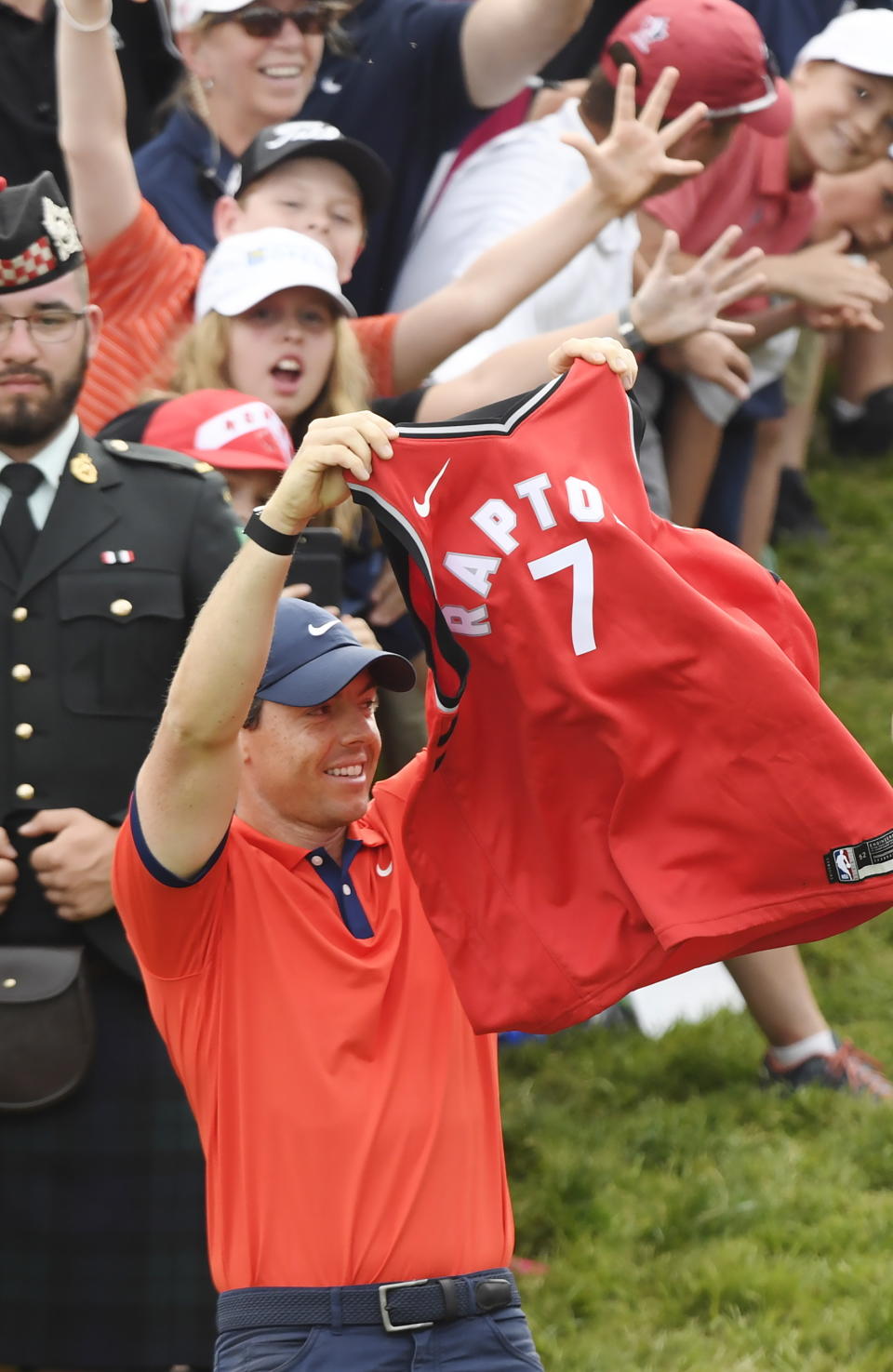 Rory McIlroy, of Northern Ireland, raises a Toronto Raptors jersey on the 18th green after winning the Canadian Open golf championship in Ancaster, Ontario, Sunday, June 9, 2019. (Nathan Denette/The Canadian Press via AP)