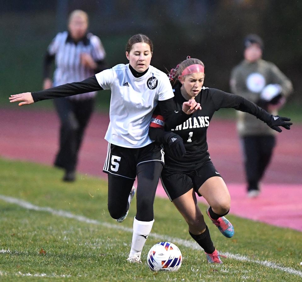 Conemaugh Township's Ashlyn Fetterman (1) battles to bring the ball down the sideline against Northern Bedford County's Lydia Barton (5) during a District 5 Class 1A girls soccer semifinal, Oct. 30, in Davidsville.