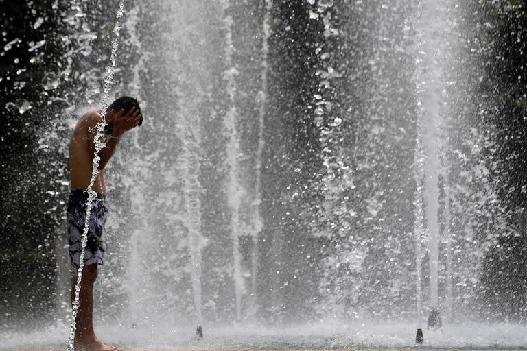 Un hombre se refresca en una fuente en Sevilla el 10 de julio cuando la temperatura llegó a los 44 grados (CRISTINA QUICLER / AFP)