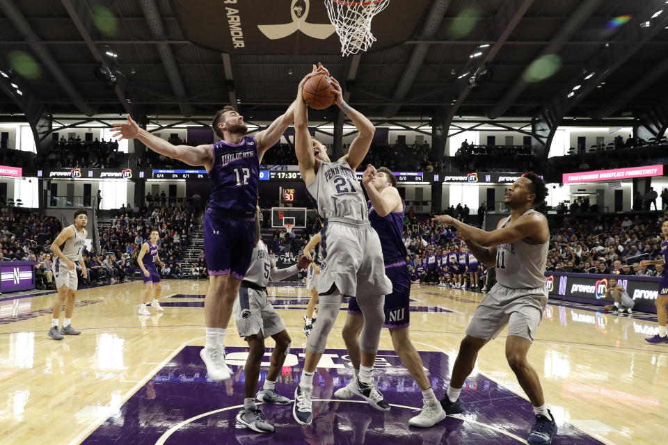 Penn State forward John Harrar (21) battles for a rebound against Northwestern guard Pat Spencer, left, and center Ryan Young during the first half of an NCAA college basketball game in Evanston, Ill., Saturday, March 7, 2020. (AP Photo/Nam Y. Huh)