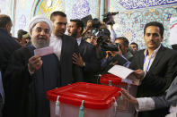 <p>In this photo released by official website of the office of the Iranian Presidency, President Hassan Rouhani holds his ballot while voting for the presidential and municipal councils election at a polling station in Tehran, Iran, May 19, 2017. Iranians began voting Friday in the country’s first presidential election since its nuclear deal with world powers, as incumbent Hassan Rouhani faced a staunch challenge from a hard-line opponent over his outreach to the wider world. (Photo: Iranian Presidency Office via AP) </p>