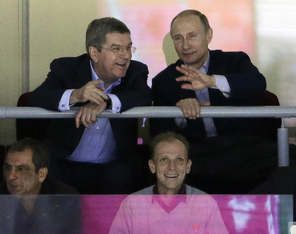 Russian President Vladimir Putin watches the USA Russia men's hockey game from a box at the 2014 Winter Olympics, Saturday, Feb. 15, 2014, in Sochi, Russia. (AP Photo/David J. Phillip )