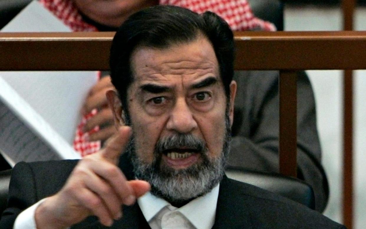 Former Iraq leader Saddam Hussein sits in court in Baghdad, Iraq, Wednesday, Dec. 6, 2006 - NIKOLA SOLIC /Reuters