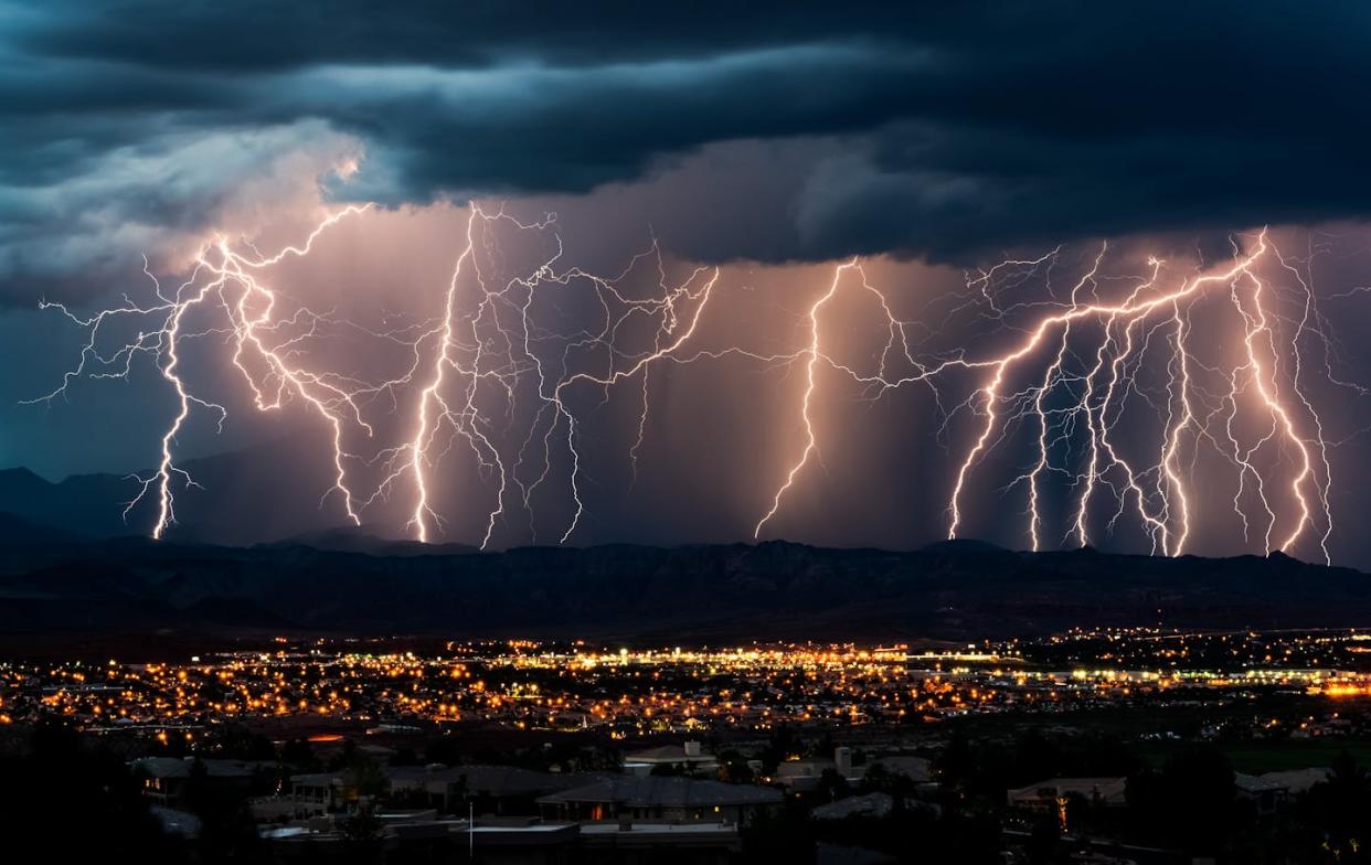 Lightning strikes near St. George, Utah. <a href="https://www.gettyimages.com/detail/photo/curtain-of-lightning-over-city-royalty-free-image/186538582" rel="nofollow noopener" target="_blank" data-ylk="slk:jerbarber/iStock/Getty Images Plus;elm:context_link;itc:0;sec:content-canvas" class="link ">jerbarber/iStock/Getty Images Plus</a>