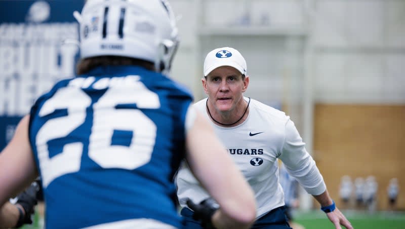 BYU defensive coordinator Jay Hill gets hands-on during spring practice at the Cougars Indoor Practice Facility in Provo.