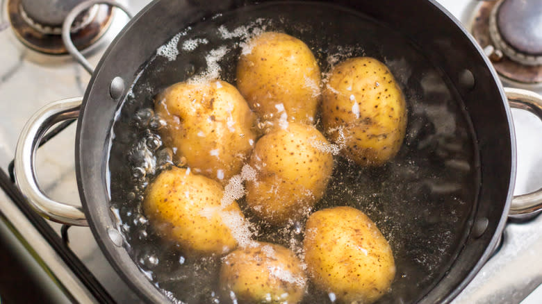 Potatoes boiling in pot