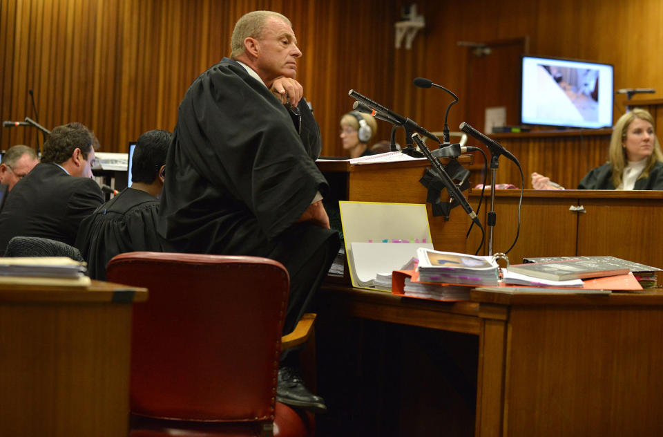 South African chief state prosecutor Gerrie Nel questions Oscar Pistorius in court in Pretoria, South Africa, Monday, April 14, 2014. A judge temporarily adjourned the murder trial of Oscar Pistorius after the athlete started to sob while testifying about the moments before he killed girlfriend Reeva Steenkamp in his home last year. (AP Photo/Antoine de Ras, Pool)